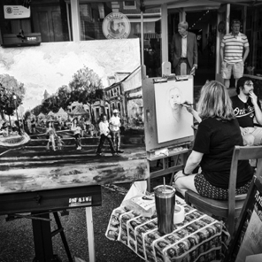 July First Friday • Pam Wilde demonstration painting outside Artists Emporium – her First Friday painting on easel